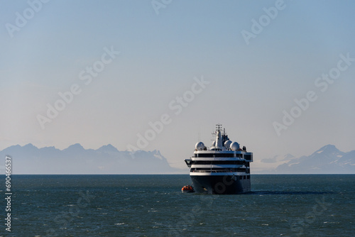 Large cruise ship in the calm ocean outside Longyearbyen, Svalbard in the arctic early in the morning on a summer day
 photo