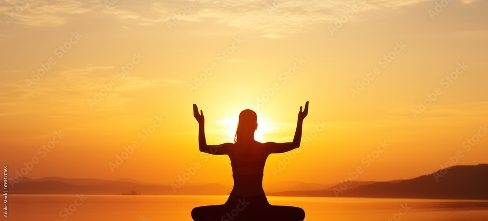 Harmony at Dawn - A Young Woman's Yoga Silhouette Merging with the Splendor of the Rising Sun