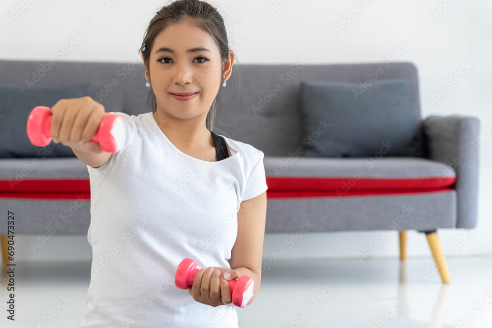 Young Woman Fitness with Dumbbell in Living Room at Home Young Woman Fitness with Dumbbell in Living Room at Home