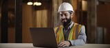 Young Arab man engineer/designer with beard showcases color palettes on laptop during remote office video meeting for construction business.