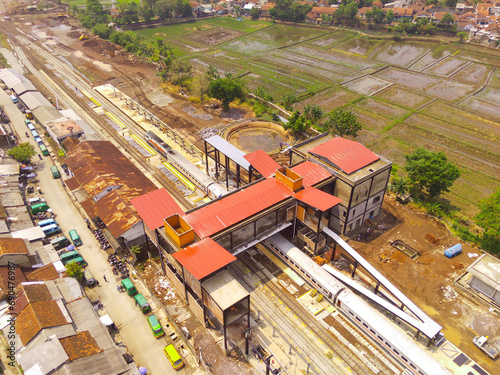 Transportation Photography. Aerial Landscapes. Drone view of Train arrival in Cicalengka, located on the edge of the city of Bandung - Indonesia. Aerial Shot from a flying drone. photo