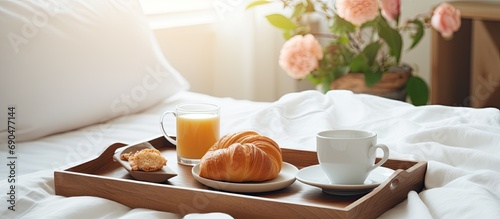 Hotel room with wooden interior, white linen tray breakfast in bed. photo