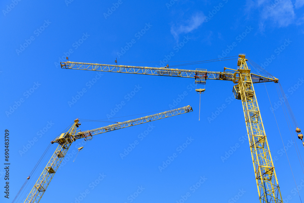 Construction site background. Construction cranes against the sky.. Construction site background. Construction cranes against the sky..