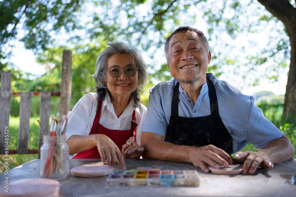 Senior couple learn how to make pottery. Senior couple learn how to make pottery.