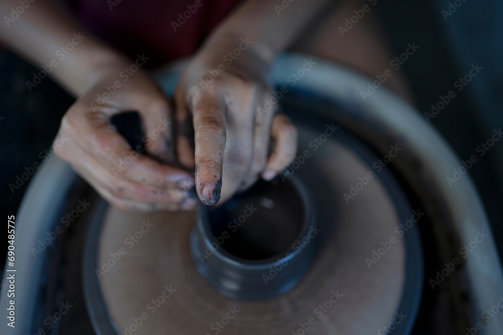 Close up of pottery making process.