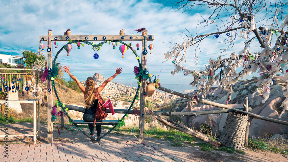 Fototapeta premium Happy traveler woman enjoying panoramic view of Cappadocia landscape with fairy rock formation, Uchisar, Goreme- Travel, tour tourism, activity in Turkey
