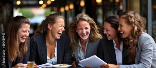 Young professionals in an office, laughing during a coffee break.