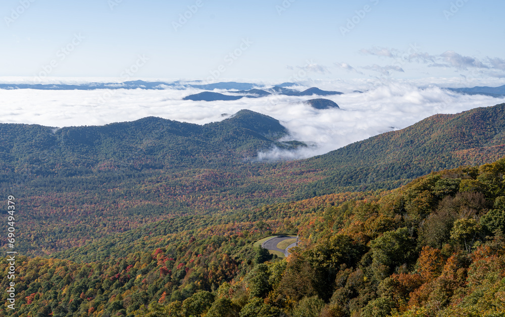 Mountain landscape in the morning with fog covered around peaks and along side road