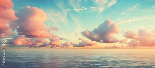 Gorgeous retro-colored sky with seawater and clouds. © AkuAku