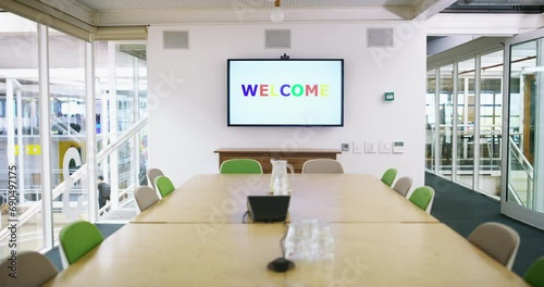 Monitor, meeting or empty office for presentation with table, chairs or corporate company. Background, conference or welcome text words on screen in modern boardroom for training or business project photo