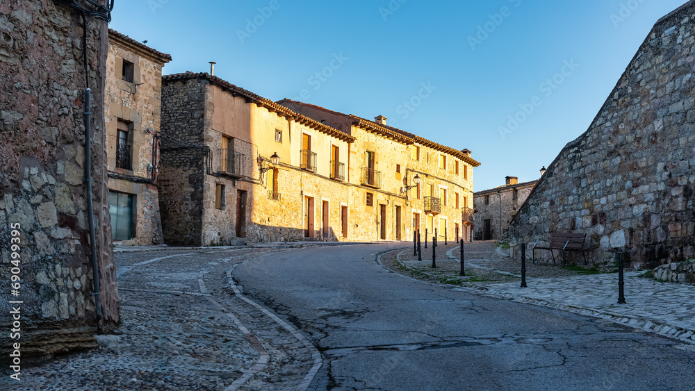 Old medieval houses and cobbled floor next to the medieval castle of the picturesque town, Siguenza.