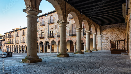 Portico with stone arches and columns in the main square of the medieval city of Siguenza.