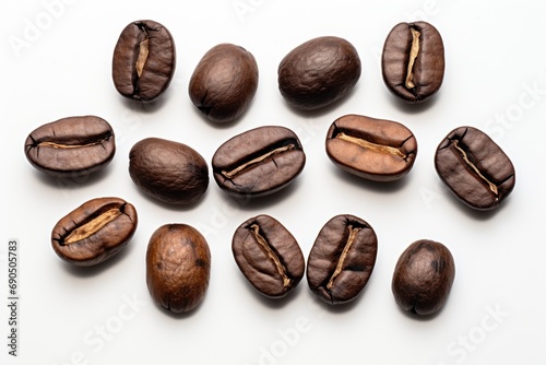  a group of coffee beans sitting on top of a white table next to a pile of coffee beans on top of a white table.