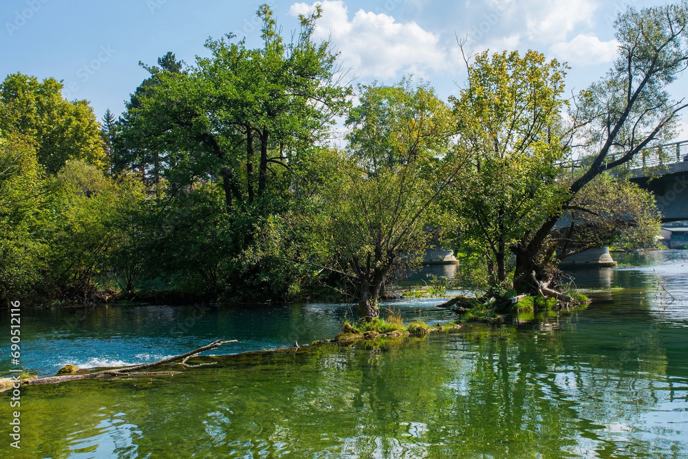 The River Una as it passes through central Bihac in Una-Sana Canton, Federation of Bosnia and Herzegovina. Most Alije Izetbegovica Bridge to the right The River Una as it passes through central Bihac in Una-Sana Canton, Federation of Bosnia and Herzegovina. Most Alije Izetbegovica Bridge to the right