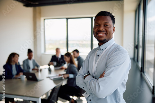 Confident black businessman during meeting in office looking at camera. photo