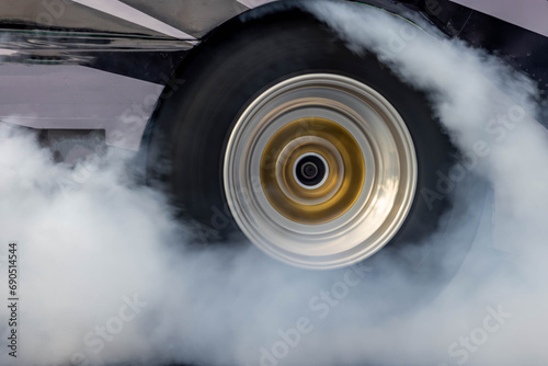Car burnout wheels tire with white smoke,Car wheel burnout with smoke from the spinning tyre, Drag car wheel burns tires preparation for the race. photo