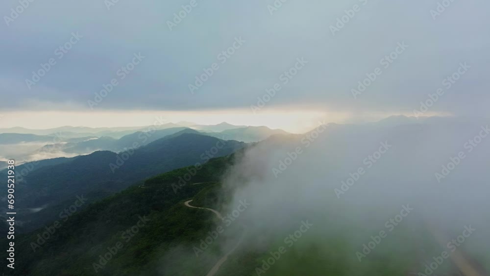 Mountain and forest landscape with clouds with aerial view from drone. Fog clouds cover the mountains and forests. Mountain and forest landscape with clouds with aerial view from drone. Fog clouds cover the mountains and forests.