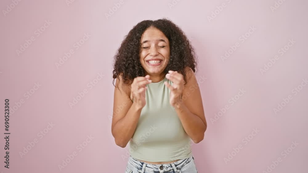 Confident and beautiful young hispanic woman radiates pure joy as she celebrates in style! standing against a cool, isolated pink background, her smile and laugh light up the frame. Confident and beautiful young hispanic woman radiates pure joy as she celebrates in style! standing against a cool, isolated pink background, her smile and laugh light up the frame.