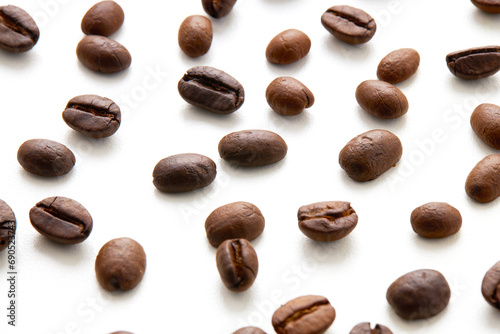 Top view Roasted coffee beans scattered isolated on a white background.