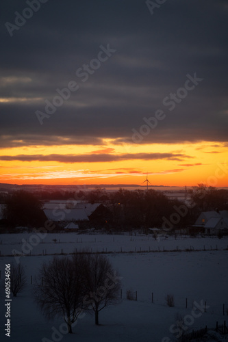 Rural landscape with wind turbine on cold winter morning with sunrise outside Lund Sweden © Michael Persson