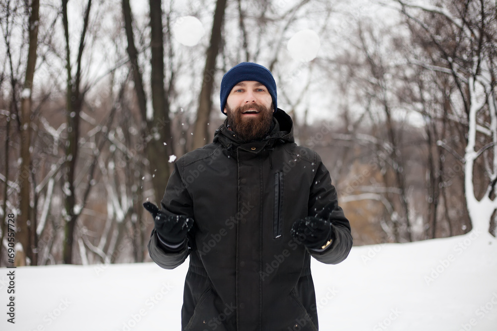 bearded guy playing snowballs