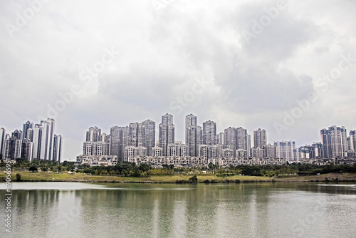 city view from the water, city skyline on the embankment with reflection. Composite image. China © Andrei