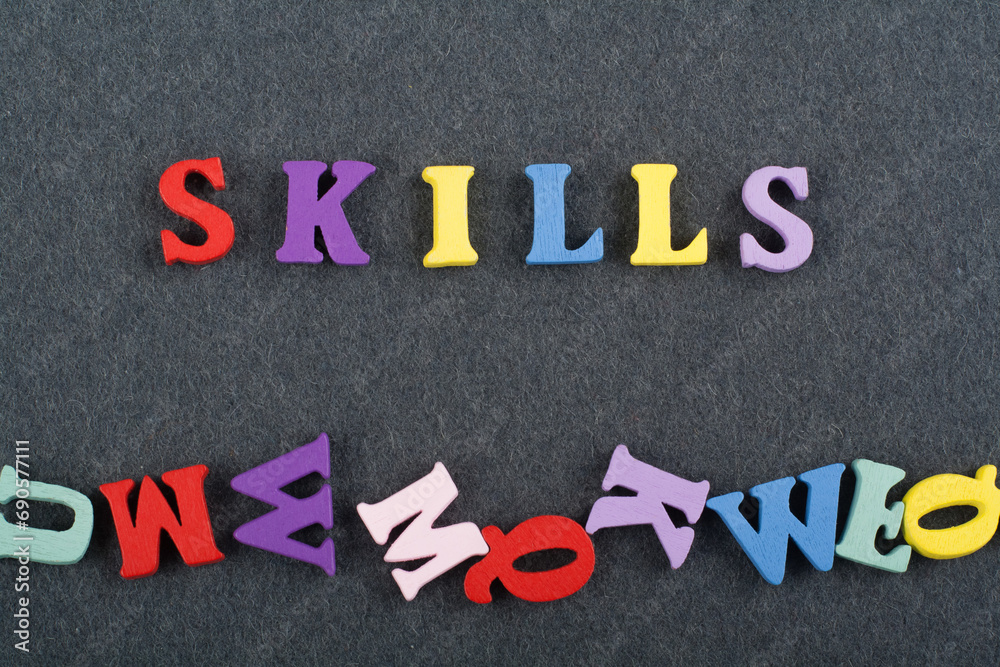 SKILLS word on black board background composed from colorful abc alphabet block wooden letters, copy space for ad text. Learning english concept. SKILLS word on black board background composed from colorful abc alphabet block wooden letters, copy space for ad text. Learning english concept.