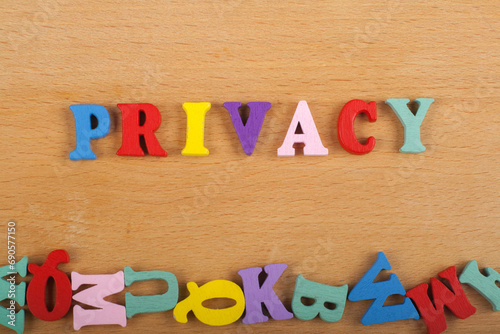 PRIVACY word on wooden background composed from colorful abc alphabet block wooden letters, copy space for ad text. Learning english concept. photo