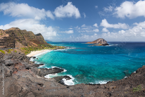 Panoramic view of Makapuu Beach and bay with its turquoise waters and Manana Island in the background from Makapuu lookout. Oahu, Honolulu, Hawaii, USA
