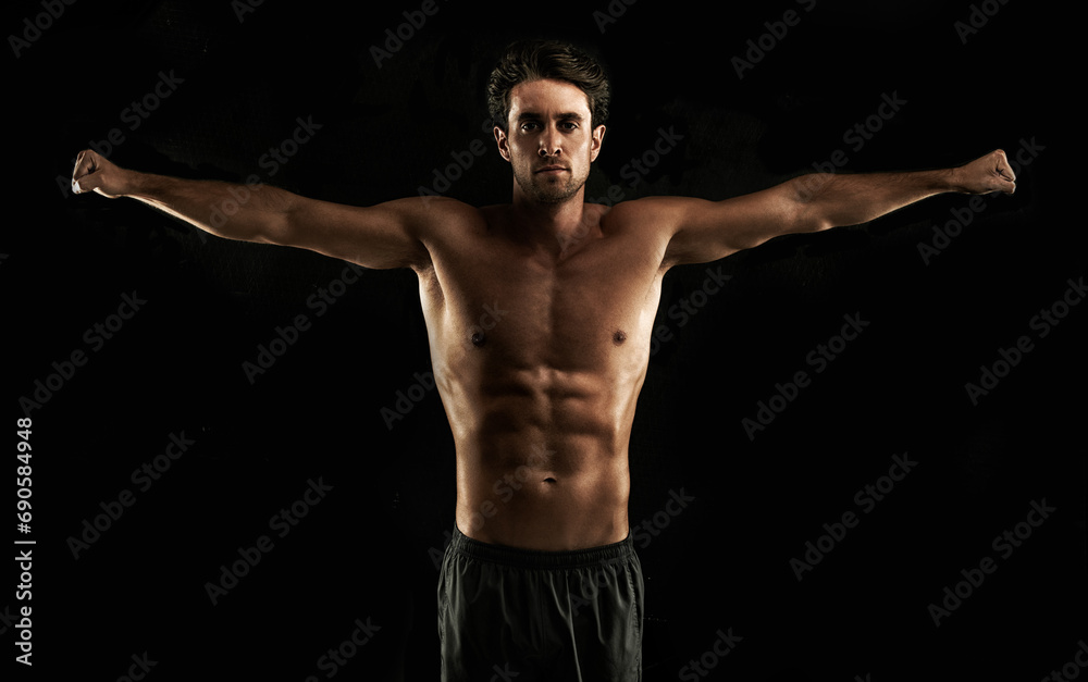 Arms raised, black background or topless man for workout, training or exercise in studio for fitness. Model, dark shadow or ripped male person with healthy body, six or stomach for wellness in Italy