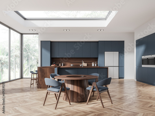 White and blue kitchen with island and dining table