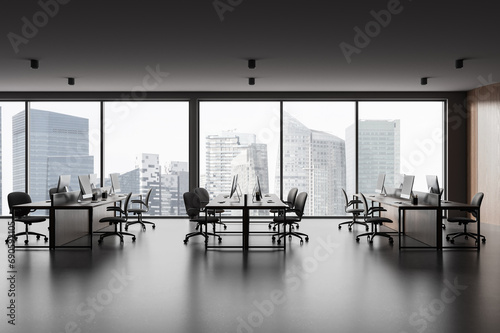 Photography Stylish office workplace interior with pc computers in row near panoramic window