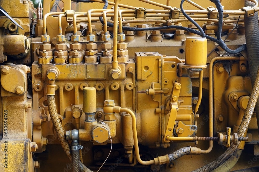 A old injector pump set of the old vintage yellow engine of a generator.