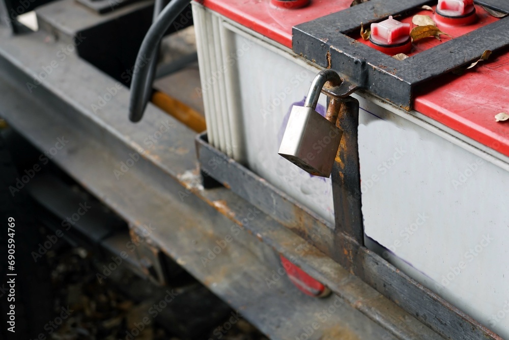 Close-up of the battery and padlock on the car. Close-up of the battery and padlock on the car.