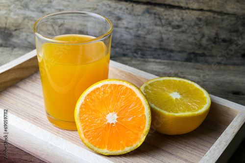 Glass of orange juice on wooden table, fresh drink