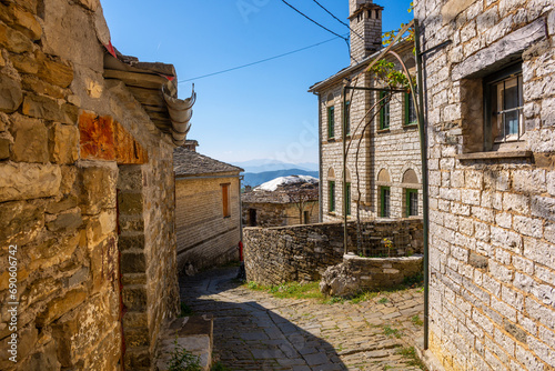 Fototapeta Naklejka Na Ścianę i Meble -  Traditional architecture in a narrow stone street during fall season in the picturesque village of papigo in Epirus zagori greece