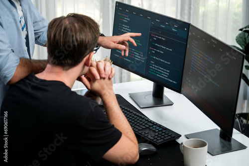 Obraz na płótnie IT developers discussing online software development information on pc screen, creating program coding for latest version application on website. Concept of brainstorming firmware updated. Sellable.