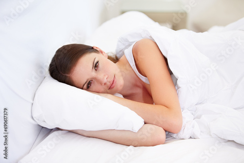 Portrait, home and bedroom with woman, resting and relax with weekend break, lazy and healthy. Face, person and apartment with girl, pillow and peace with freedom, cushion and blanket with wellness