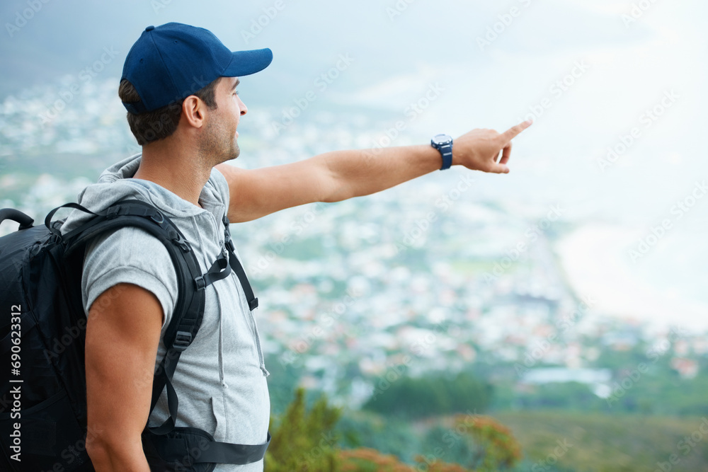 Outdoor, hiking and man with nature, pointing and adventure with direction, journey and fitness. Person, hiker and guy with wellness, travel or location with fresh air, forest or landscape with view - obrazy, fototapety, plakaty 