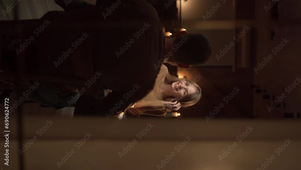 Valentine's Day celebration concept. Young couple having dinner in the evening at home talking and enjoying each other Valentine's Day celebration concept. Young couple having dinner in the evening at home talking and enjoying each other