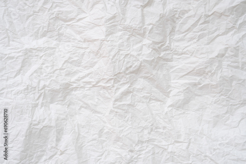 Wrinkled or crumpled white stencil paper or tissue after use in toilet or restroom with large copy space used for background texture in decorative art work