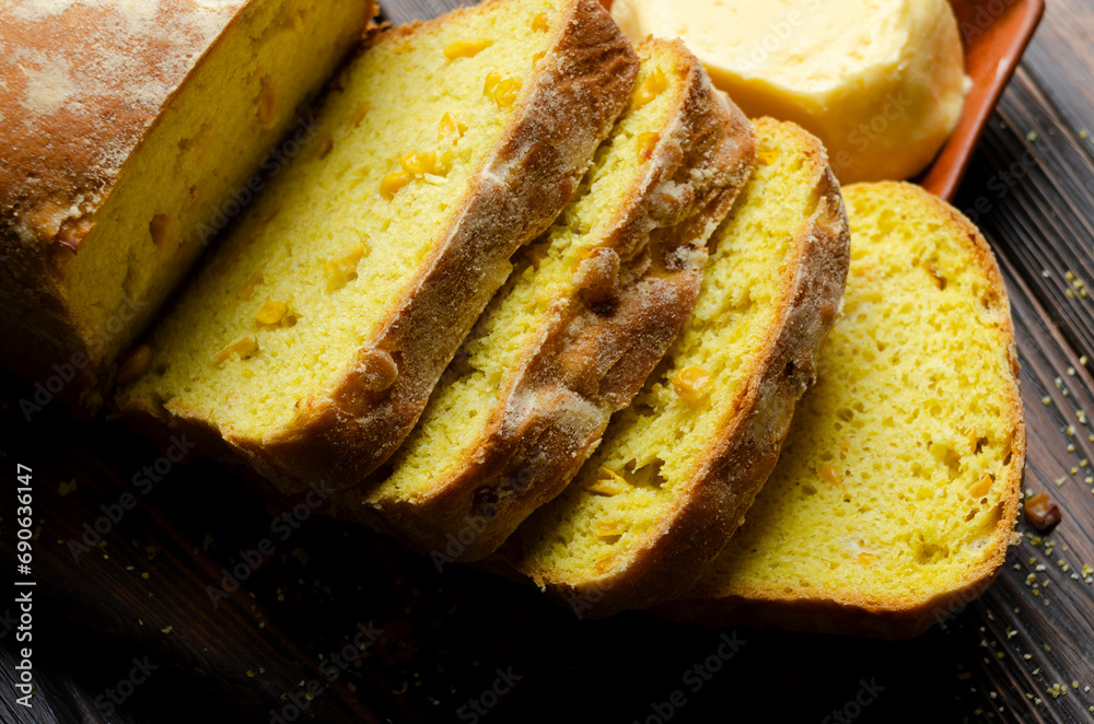 Homemade cornbread slices and butter on kitchen table