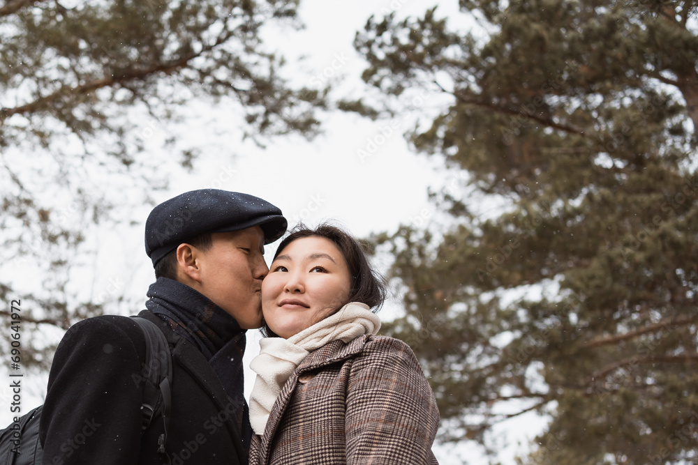 Fototapeta premium Young asian couple in love walking in winter park