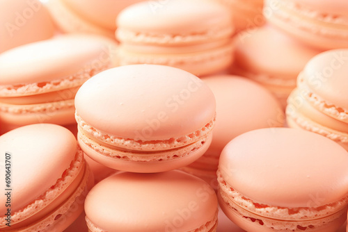 many vertical stacks of macaroons background in peach fuzz color photo