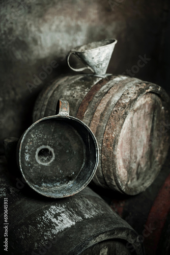 Old vintage wine barrels, an old metal watering can 