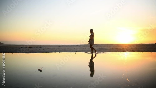 Sunset, woman on beach, phone and picture on walk on tropical island for holiday, adventure and freedom. Travel, peace and girl on vacation to relax, photography and person in sunshine, glow and sky. photo
