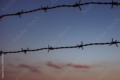 barbed wire in front of red sky during sunset  2 