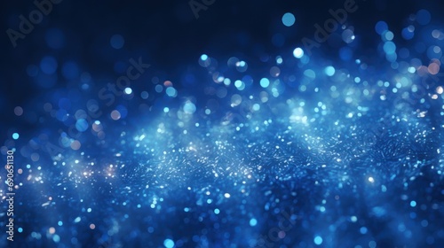Abstract background of dark blue particles and soft blurred glow.