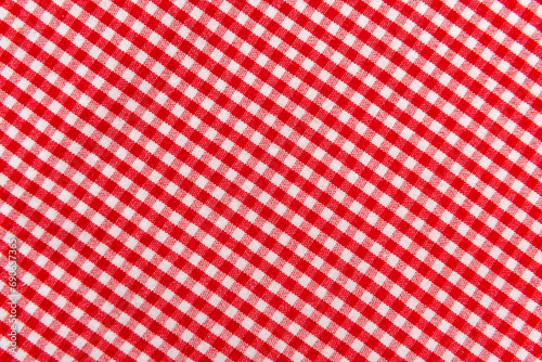 The texture of linen fabric in a large cage of red and white. Scottish tailoring material. Checkered fabric
