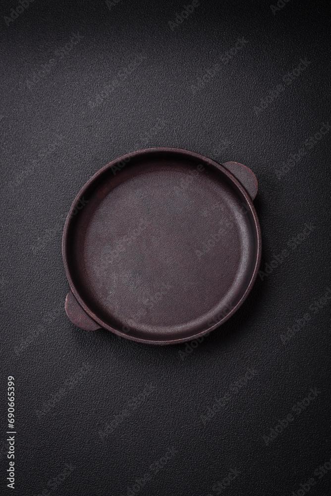 Bumpy empty ceramic plate on a textured concrete background Bumpy empty ceramic plate on a textured concrete background